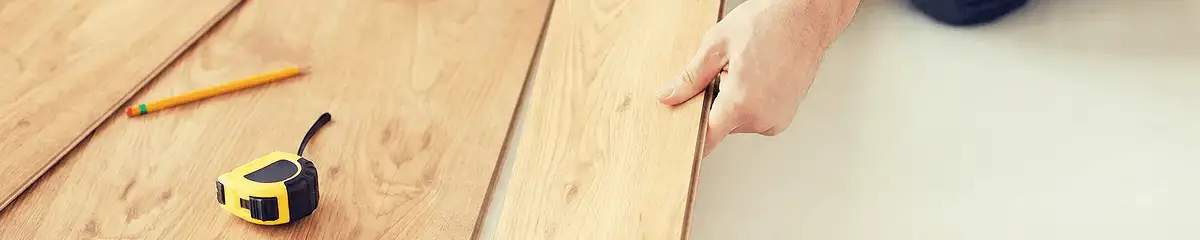 A professional installing wood flooring in Hialeah, FL