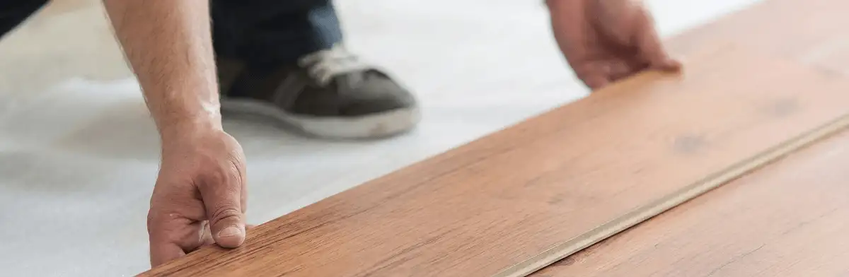 A professional installing laminate flooring in Hialeah, FL